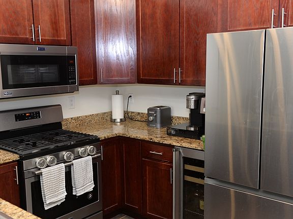 Kitchen with brand new wine fridge and adjacent brand new washer/dryer.