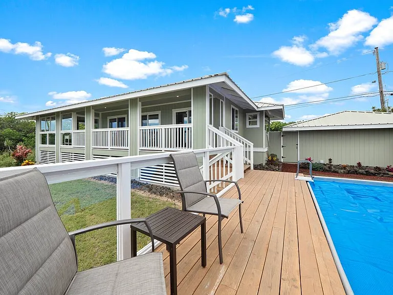 Backyard pool has seating area - for watching kids, grandkids, or keeping your adult beverages close!
