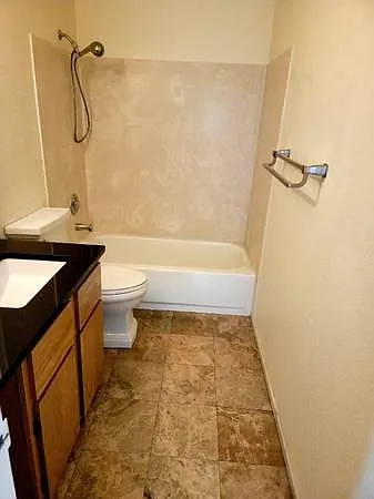Main Bathroom with Tub, Shower and Mocha Marble Flooring