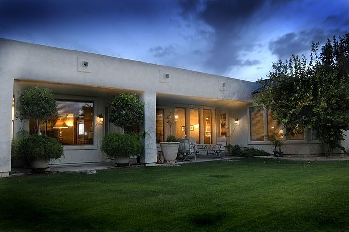 Back yard is large and lush with mature citrus. Backs to green belt.