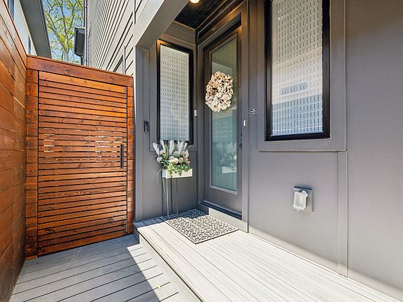 The owners built a beautiful, architecturally pleasing privacy fence and gate creating a personal walkway to the main entrance of the home. Electric lock and security features added.