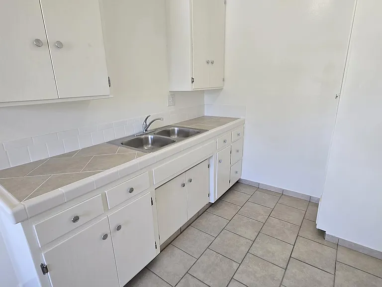 Kitchen with tiled flooring.