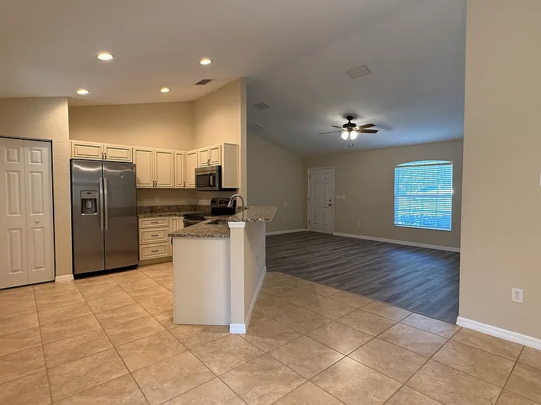 Kitchen, dining, living room and front door view.