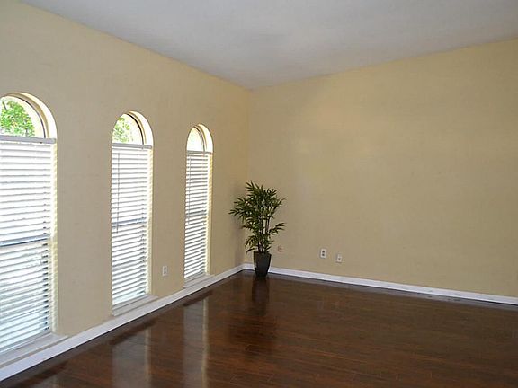 Formal living area with lots of windows with natural light flow.