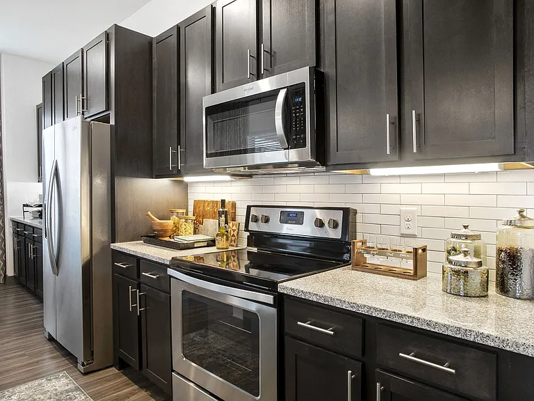 Gourmet kitchens feature granite countertops and tile backsplash.