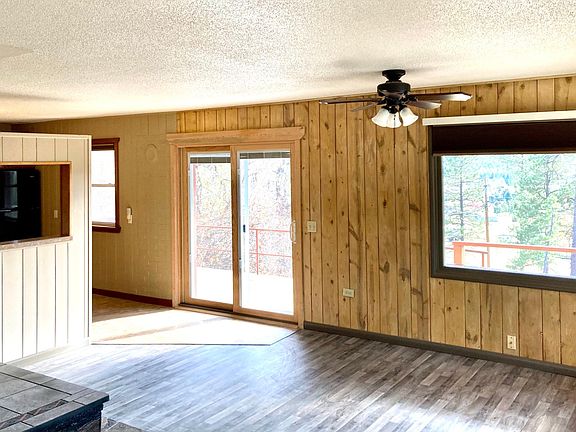 Living room looking out into the pine trees.