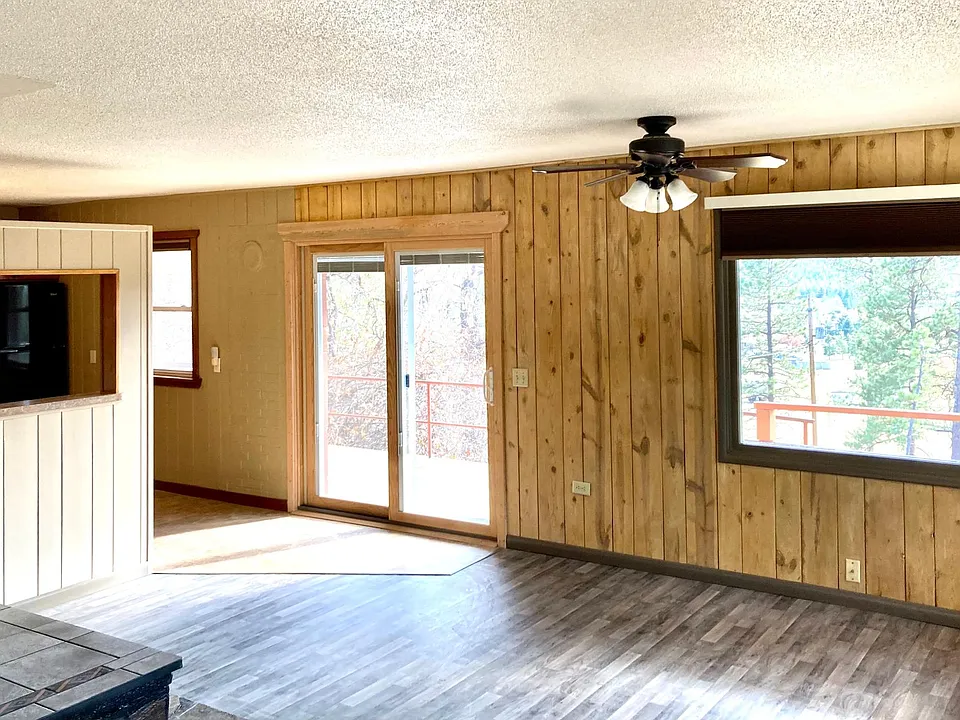 Living room looking out into the pine trees.