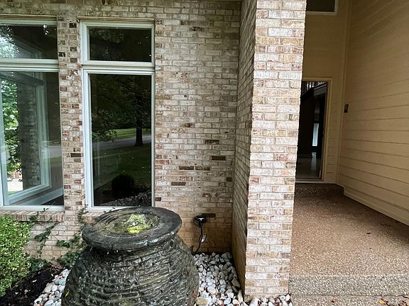 Oscillating, lighted, bubbling water fountain @ entrance. This feature is operable by remote control. Waterfall located @ back of property which serves as the entrance to walk-out basement.