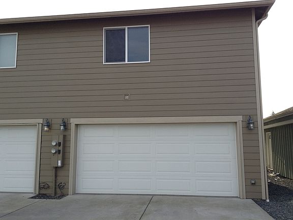 Two car garage with overhead storage rack.