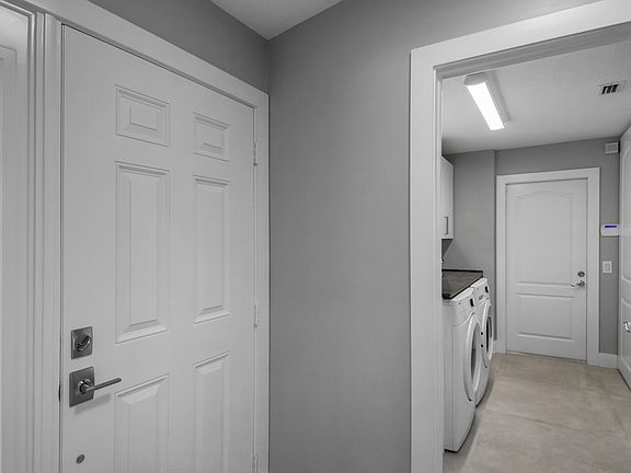 entrance from door , to the left laundry room leading to garage.
