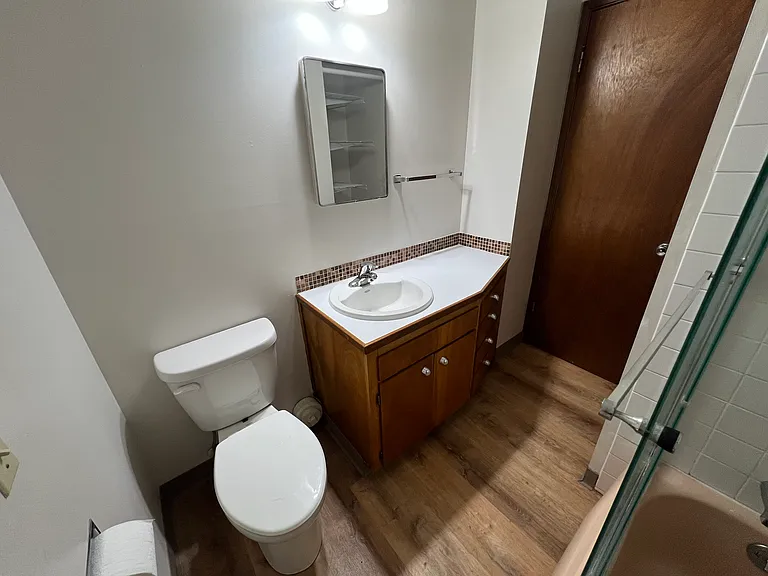 sink vanity has 4 drawers and cupboard doors , opening medicine cabinet above , lots of storage