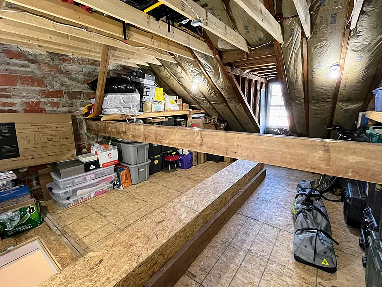 Full-size adult bikes and storage bins are easy to get into the attic with the larger attic access drop-down ladder.