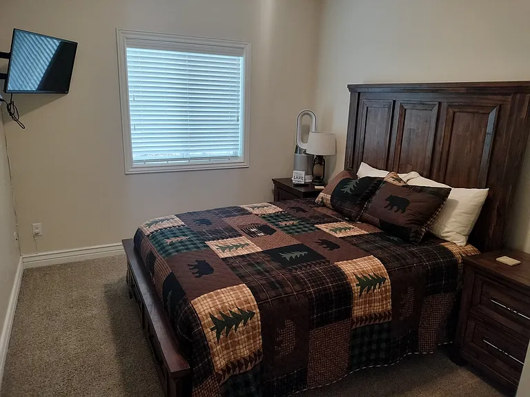 Two inviting guest bedrooms feature Smart TVs and convenient touch lighting, offering comfort and modern amenities for a relaxing stay. Perfect for unwinding and enjoying a restful night.