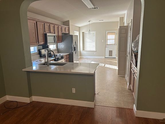 This is a better view of the back of the kitchen which has a dining area.