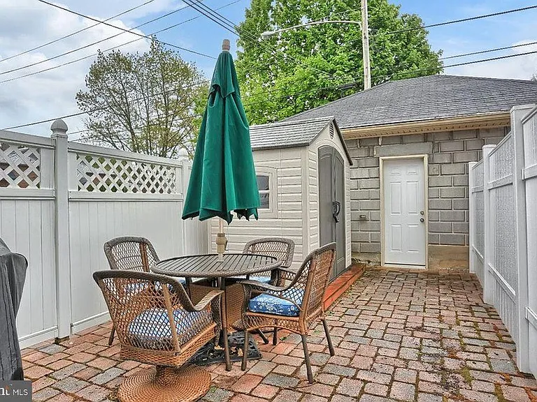 fenced area with storage shed