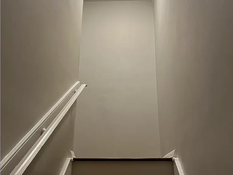 Stairway to upstairs is well-lit with hand rails