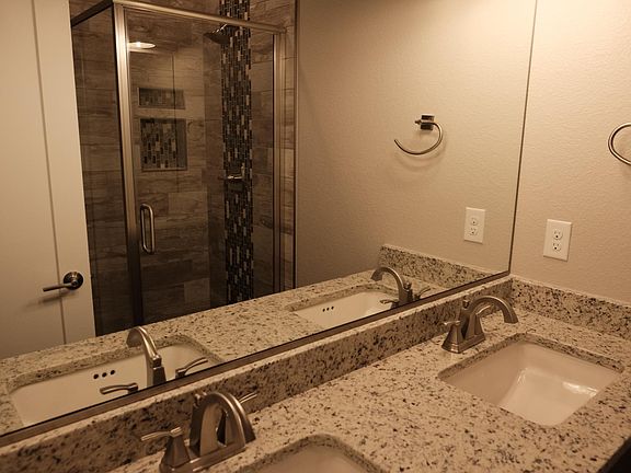 Double sink vanity and glass shower enclosure