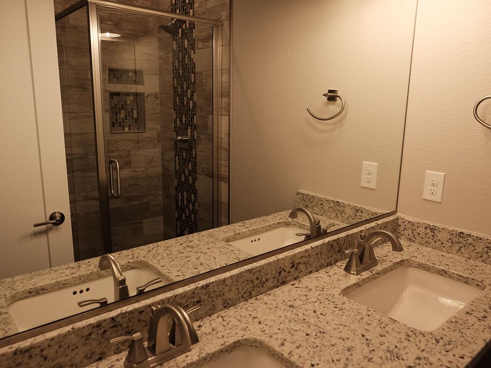 Double sink vanity and glass shower enclosure