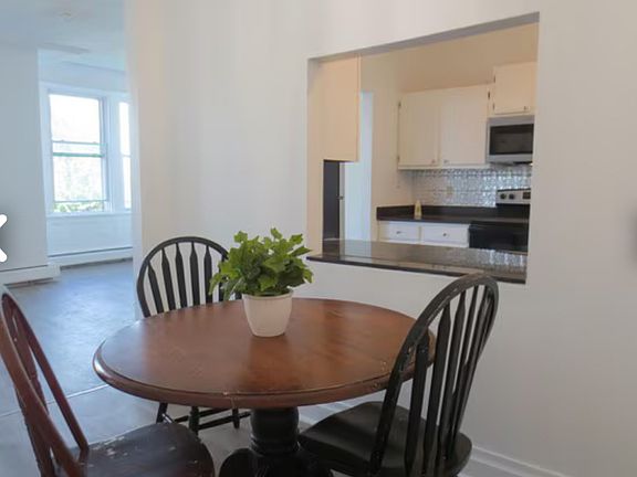 Dining room with living room and kitchen in foreground