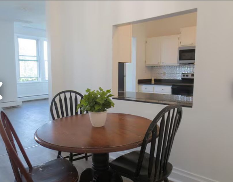Dining room with living room and kitchen in foreground