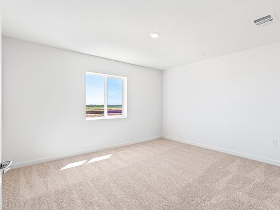 The master bedroom is spacious with a large window.