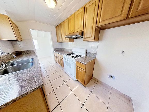 Kitchen with included range-oven and hood-range.