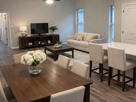From dining room and kitchen side looking back towards living room