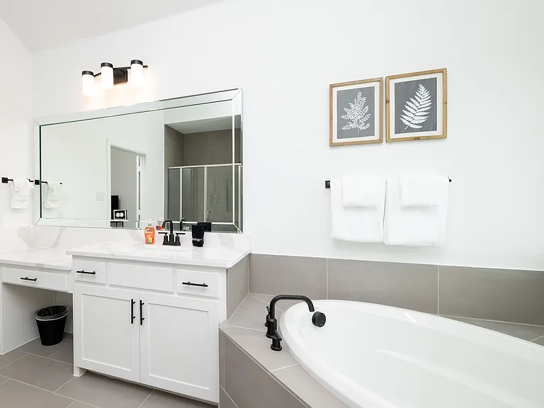 Primary bathroom has a garden tub, two sinks, and a walk-in shower