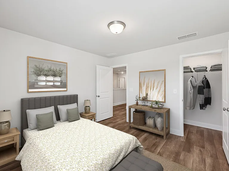 Secondary bedroom with a large bed and a wooden nightstand.