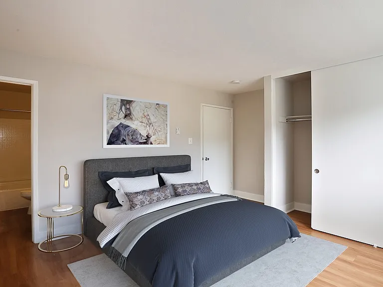 Bedroom with a large closet and wood flooring