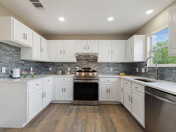 Large kitchen with custom backsplash and new Samsung Stainless Steel appliances