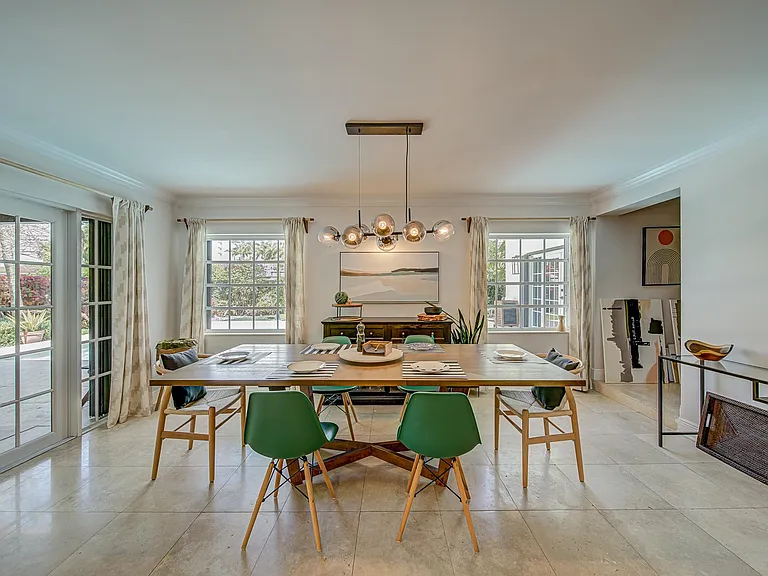 Dining room get lots of natural light as it overlooks the swimming pool. There is enough room for a large dining table to accommodate between 6-10 people.
