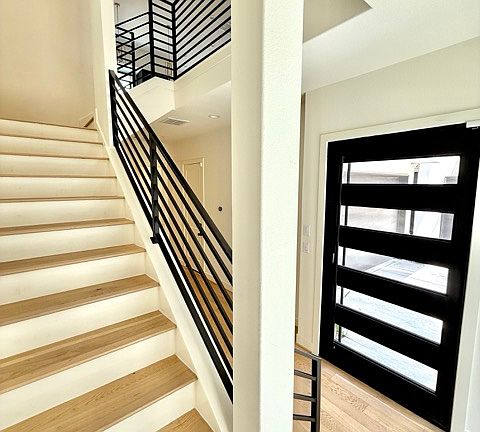 Entryway featuring steel sound proof front door.