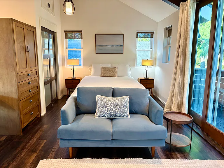 The bedroom in the studio is set back and surrounded by natural light.