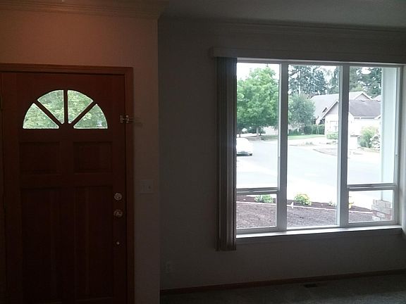 Entry way and formal living room with crown molding.
