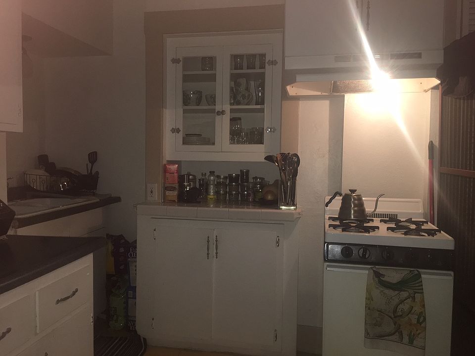 Looking into kitchen from living area. Can view range in th