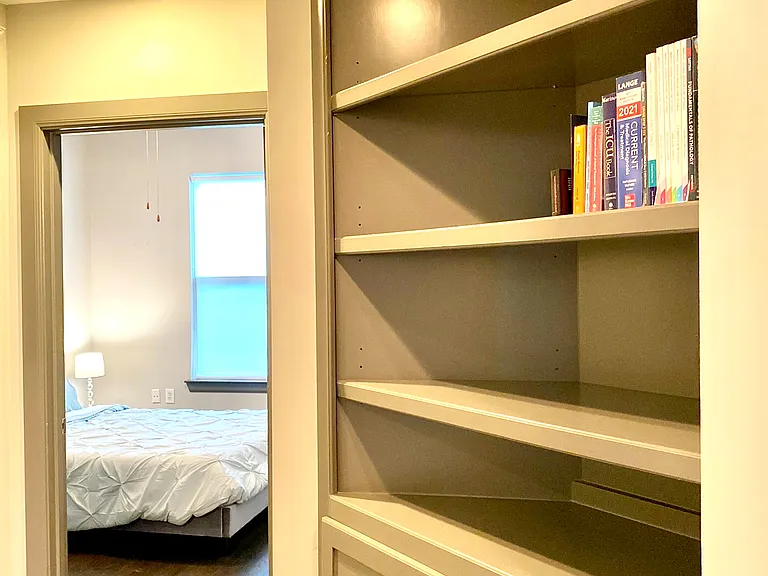 Built-in bookshelves on the way to your guest bedroom with plenty of closet space throughout the unit, including both bedrooms and the hallway!