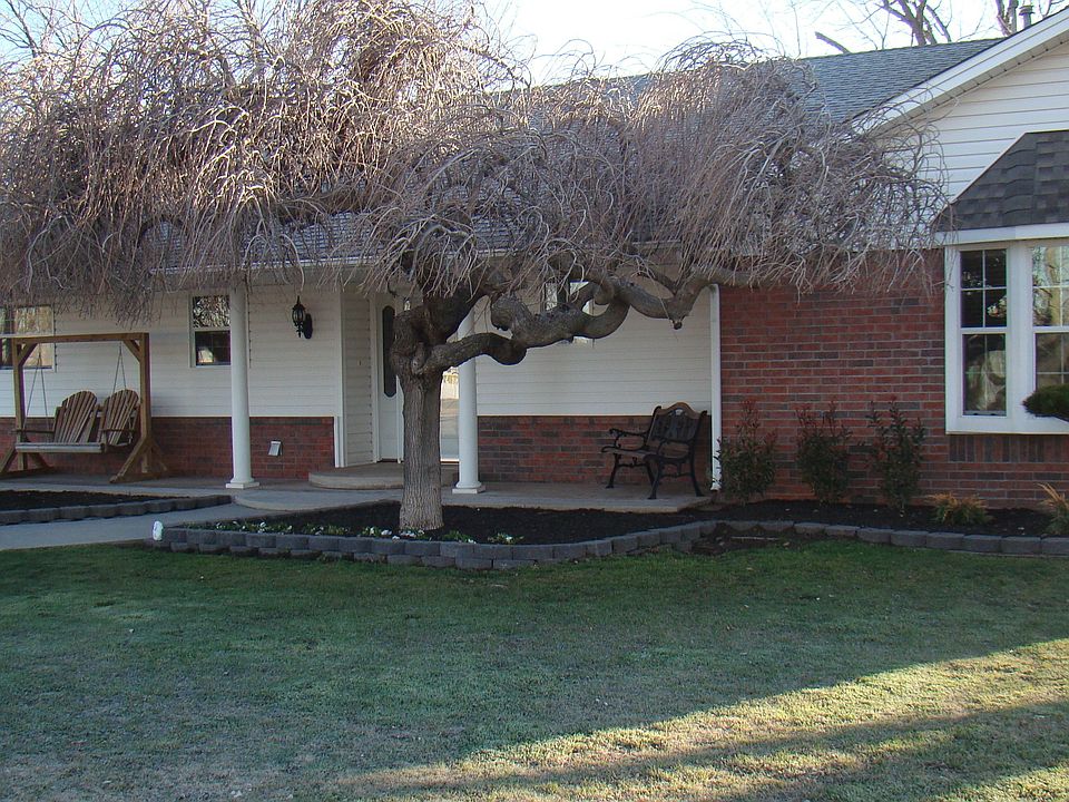 Manicured landscaping and great trees shade the over sized front porch.