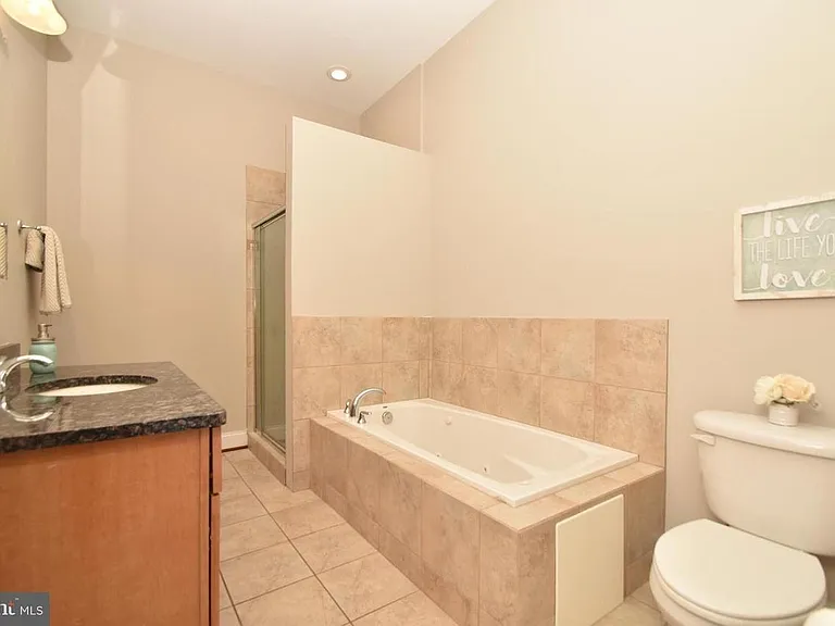 Bathroom 2 features a large soaking tub with separate shower