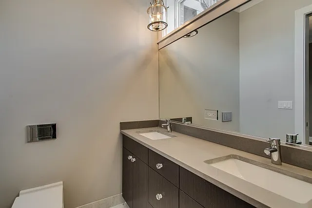 En suite bathroom complete with double sink vanity and steam shower