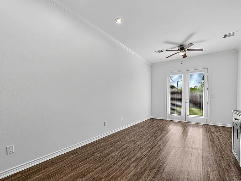 Bright living area with high ceilings and abundant natural light.