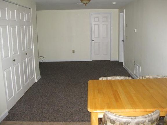 Living room (from the kitchen). Bedroom doors in the back.