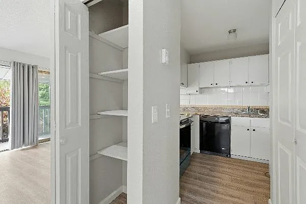 Small pantry off the kitchen across from the larger pantry