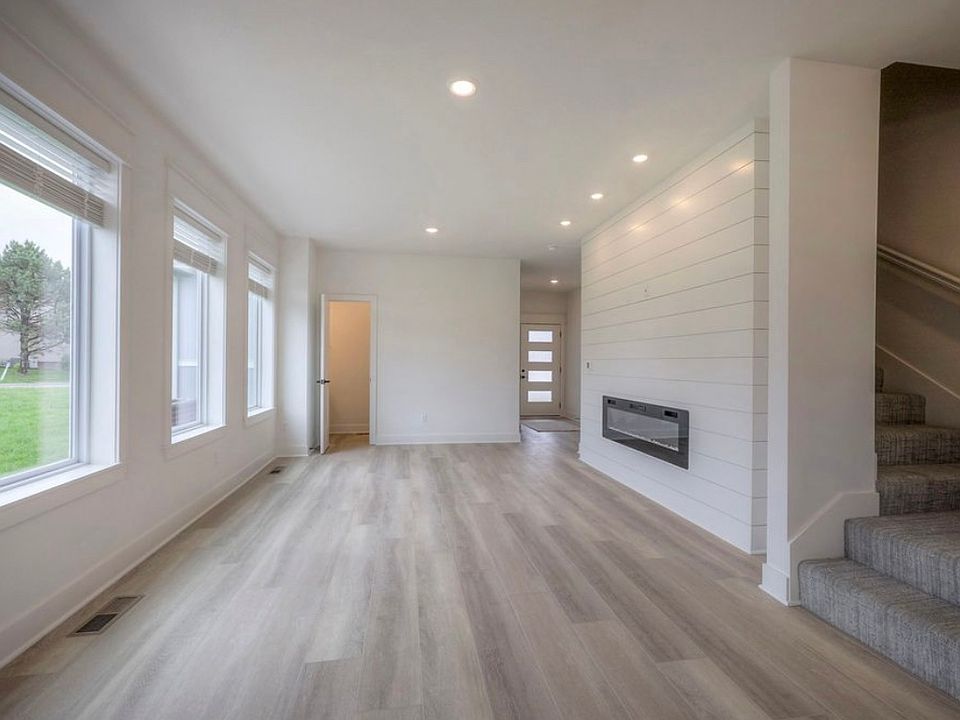 Bright Open Living Space with Electric Fireplace & Natural Light