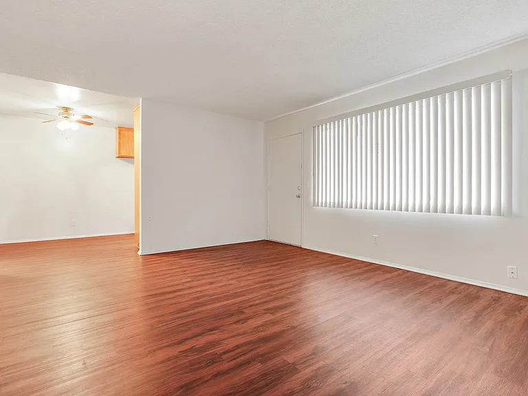 Living room with wood style floors throughout the kitchen