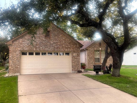 Garage has a small work bench and garage attic access with storage above with climate controlled vent fan.