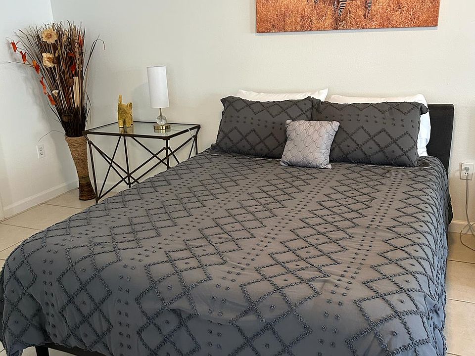 Beautiful queen bed with premium linens, cozy pillows, and elegant decor.