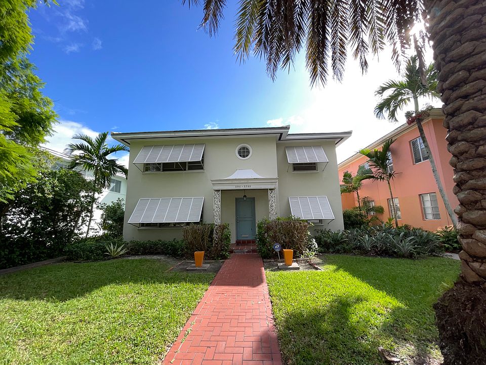 Front entrance facing Ponce with Bahama shutters on front windows to provide privacy and shade.