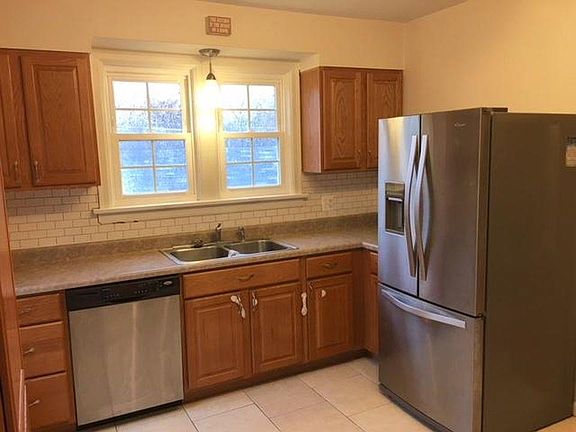 Kitchen with windows overlooking the backyard.