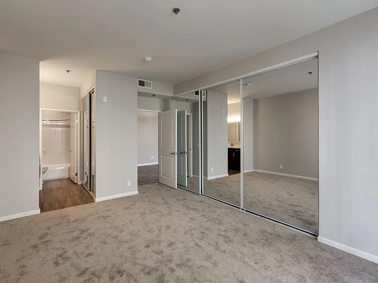 Chelsea Court One Bedroom Mirrored Closet and View of Bathroom